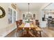 Bright dining area features a large window, wood floors, light fixture, and a decorative plate display at 282 Brodie Rose Landing Way, Smithfield, NC 27577