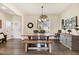 Charming dining room featuring a large window, modern lighting, wood floors, and a decorative plate display at 282 Brodie Rose Landing Way, Smithfield, NC 27577