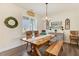 This dining room features wood floors, large window, light fixture, and a decorative plate display at 282 Brodie Rose Landing Way, Smithfield, NC 27577