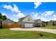 View of the home showing a well-maintained lawn and extended driveway to the garage at 282 Brodie Rose Landing Way, Smithfield, NC 27577