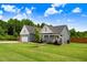 Well-maintained house with green lawn and complementary landscaping boasts covered front porch and attached garage at 282 Brodie Rose Landing Way, Smithfield, NC 27577
