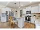 Modern kitchen with stainless steel appliances, granite countertops, kitchen island, and light wood floors at 282 Brodie Rose Landing Way, Smithfield, NC 27577