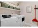 Functional laundry room featuring a washer, dryer, and ample storage space at 282 Brodie Rose Landing Way, Smithfield, NC 27577