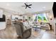 Inviting living room with lots of natural light, wood floors, open concept to kitchen and backyard access at 282 Brodie Rose Landing Way, Smithfield, NC 27577