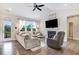 Cozy living room features a fireplace, tv, large window, and comfortable seating at 282 Brodie Rose Landing Way, Smithfield, NC 27577