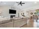 Cozy living room with a fireplace, comfortable seating, wood floors, and an open view to the dining area at 282 Brodie Rose Landing Way, Smithfield, NC 27577