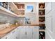 Well-organized pantry featuring custom shelving, butcher block countertop, and ample storage space at 282 Brodie Rose Landing Way, Smithfield, NC 27577