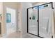 Modern bathroom with a glass-enclosed shower, neutral tile, and bright natural light at 282 Brodie Rose Landing Way, Smithfield, NC 27577