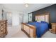 Bright bedroom features a wooden bed frame, walk-in closet, and neutral carpeting at 283 Daniel Ridge Rd, Wendell, NC 27591