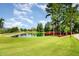 Picturesque community pond with a charming wooden bridge and lush greenery, perfect for relaxing and enjoying nature at 283 Daniel Ridge Rd, Wendell, NC 27591
