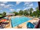 Resort-style community pool featuring colorful umbrellas and plenty of lounge chairs for a relaxing day in the sun at 283 Daniel Ridge Rd, Wendell, NC 27591