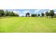 Expansive green community space with modern open-air wooden structure under a blue sky at 283 Daniel Ridge Rd, Wendell, NC 27591