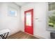 Bright entryway with a vibrant red door, modern accents, and smooth flooring at 283 Daniel Ridge Rd, Wendell, NC 27591