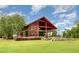 Spacious event space with rustic beams, large windows and outdoor patio with landscaping at 283 Daniel Ridge Rd, Wendell, NC 27591
