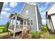 Exterior view of home with blue siding, porch, and wooden steps with stone accents at 283 Daniel Ridge Rd, Wendell, NC 27591