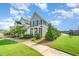 Charming two-story home with manicured lawn and sidewalks, showcasing a welcoming neighborhood at 283 Daniel Ridge Rd, Wendell, NC 27591