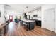 Open-concept kitchen featuring an island with barstools, stainless appliances, and modern finishes at 283 Daniel Ridge Rd, Wendell, NC 27591