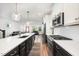 Modern kitchen features a large island with white countertops and dark cabinets, open to the living room at 283 Daniel Ridge Rd, Wendell, NC 27591
