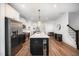 Bright, modern kitchen with stainless steel appliances, a large island, and hardwood floors at 283 Daniel Ridge Rd, Wendell, NC 27591