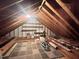 Unfinished attic with wooden beams, storage shelves, and ample storage space at 2900 Sylvania Dr, Raleigh, NC 27607