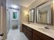 Bathroom features double sinks with marble countertops, wooden cabinets, and glass-enclosed shower at 2900 Sylvania Dr, Raleigh, NC 27607