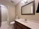 Bathroom showcasing vanity with a marble countertop, a large mirror, and a toilet, providing a functional space at 2900 Sylvania Dr, Raleigh, NC 27607