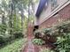 Charming brick home with well-manicured landscaping and a cozy deck area, surrounded by towering trees at 2900 Sylvania Dr, Raleigh, NC 27607