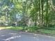 Charming home with lush front yard and mature trees creating a serene setting at 2900 Sylvania Dr, Raleigh, NC 27607