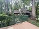 Secluded home with wood fence and established trees offering shade and privacy at 2900 Sylvania Dr, Raleigh, NC 27607