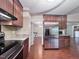 Kitchen showcases stainless steel refrigerator, granite counters, and view to the living room at 2900 Sylvania Dr, Raleigh, NC 27607
