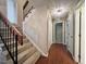 Carpeted staircase with wood railing and black balusters, illuminated by a chandelier in a hallway at 2900 Sylvania Dr, Raleigh, NC 27607