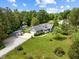 Aerial view of landscaped home with large lot, mature trees and an outbuilding at 304 Foxcroft Dr, Timberlake, NC 27583