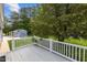 Outdoor deck with white railings offering a backyard view and a glimpse of a blue storage shed in the distance at 304 Foxcroft Dr, Timberlake, NC 27583