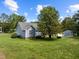 Expansive backyard with mature tree, shed and lush green grass at 304 Foxcroft Dr, Timberlake, NC 27583
