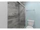 Bathroom with a glass-doored shower and gray tile at 304 Foxcroft Dr, Timberlake, NC 27583