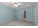 Bedroom with light blue walls, a ceiling fan, and carpet flooring with closet at 304 Foxcroft Dr, Timberlake, NC 27583