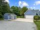Charming blue home featuring a large driveway, outbuilding and attached two-car garage at 304 Foxcroft Dr, Timberlake, NC 27583