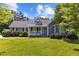 Charming blue house with a well-manicured lawn and tasteful landscaping at 304 Foxcroft Dr, Timberlake, NC 27583