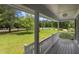 Inviting front porch with white railings overlooks a lush green lawn and tree-lined street, perfect for relaxing outdoors at 304 Foxcroft Dr, Timberlake, NC 27583