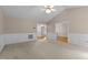 Large living room with wainscoting, carpet, ceiling fan and multiple access points at 304 Foxcroft Dr, Timberlake, NC 27583