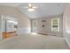 Open concept living room with a ceiling fan, carpet, and views into the kitchen at 304 Foxcroft Dr, Timberlake, NC 27583