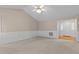 Spacious living room with plush carpet, ceiling fan, and white wainscoting detail at 304 Foxcroft Dr, Timberlake, NC 27583