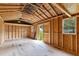 Spacious unfinished storage shed interior, featuring exposed framing and ample natural light, ready for customization at 304 Foxcroft Dr, Timberlake, NC 27583