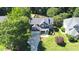 Aerial view of a charming two-story home with a manicured lawn and mature trees at 308 Wescott Ridge Dr, Holly Springs, NC 27540