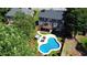 Aerial view of a home with an in-ground pool, deck, and manicured landscaping at 308 Wescott Ridge Dr, Holly Springs, NC 27540