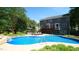 The property's backyard features a swimming pool, landscaped gardens, and a deck for relaxation and entertainment at 308 Wescott Ridge Dr, Holly Springs, NC 27540