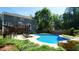 Spacious backyard with an in-ground pool, rock waterfall, and lush greenery for a private retreat at 308 Wescott Ridge Dr, Holly Springs, NC 27540
