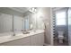 Bright bathroom boasts a double sink vanity, large mirror, and a separate toilet and shower area at 308 Wescott Ridge Dr, Holly Springs, NC 27540