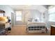 Cozy bedroom features blue and white bedding, decorative wall lights, and a light-filled window at 308 Wescott Ridge Dr, Holly Springs, NC 27540