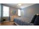 Comfortable bedroom features light blue walls, a queen-sized bed with blue bedding, and two bright windows at 308 Wescott Ridge Dr, Holly Springs, NC 27540